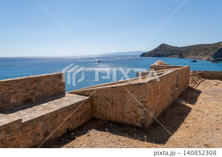 Historic Venetian fortification overlooking blue sea on Spinalonga island Greece Historic Venetian fortification overlooking blue sea on Spinalonga island Greece 140852308