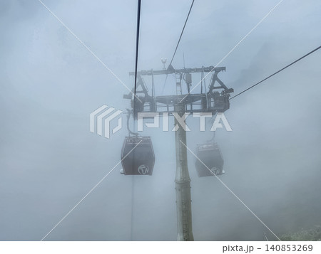Genting Highlands cable car gondola with Coach branding in fog above mountain resort in Pahang Malaysia 140853269