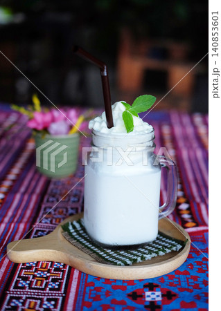 Fresh a clear glass coconut milk shake on the table in cafe of Thailand Fresh a clear glass coconut milk shake on the table in cafe of Thailand 140853601
