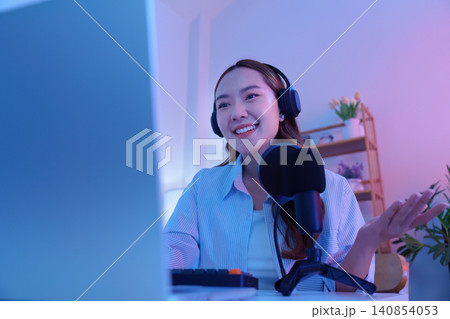 Asian woman speaking into microphone for podcast and live streaming Asian woman speaking into microphone for podcast and live streaming 140854053