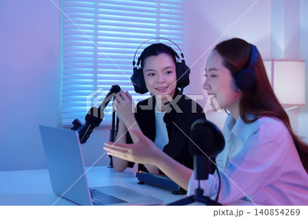 Two Asian women co hosting podcast and live streaming in home studio 140854269