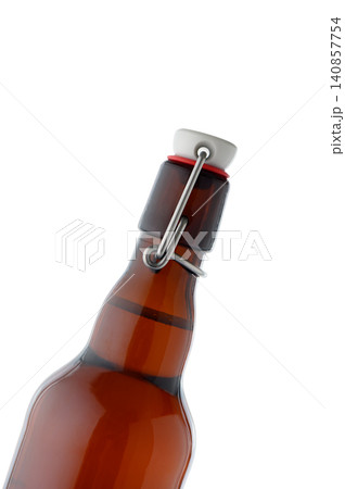 Clear Liquid in Dark Glass Swing Top Bottle Close Up Clear Liquid in Dark Glass Swing Top Bottle Close Up 140857754
