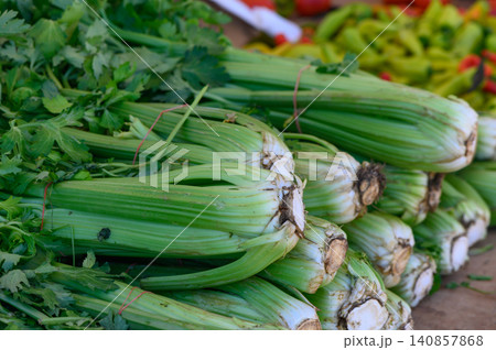 Freshly harvested celery and cilantro at a vibrant farmers market showcase early autumn's bountiful produce selection Freshly harvested celery and cilantro at a vibrant farmers market showcase early autumn's bountiful produce selection 140857868
