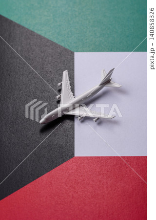 An airplane on the Kuwaiti flag as a conceptual backdrop for travel. An airplane on the Kuwaiti flag An airplane on the Kuwaiti flag as a conceptual backdrop for travel. An airplane on the Kuwaiti flag 140858326