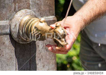 Close-up of a Hand Spout of Fountain to Drink Fresh Water in Europe street Close-up of a Hand Spout of Fountain to Drink Fresh Water in Europe street 140858434