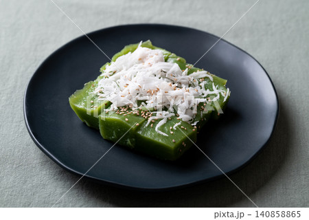 Traditional Thai dessert, pandan sweet pudding topped with coconut and toasted sesame seeds Traditional Thai dessert, pandan sweet pudding topped with coconut and toasted sesame seeds 140858865
