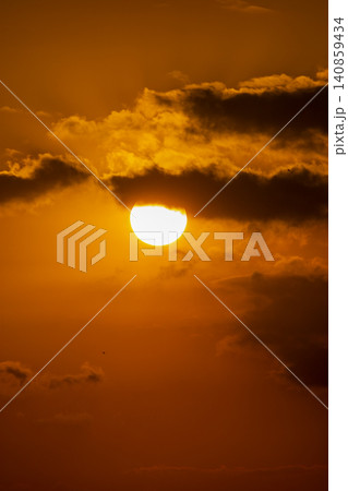 Beautiful golden sunset over the river with a small boat and sun reflection on the water. Beautiful golden sunset over the river with a small boat and sun reflection on the water. 140859434