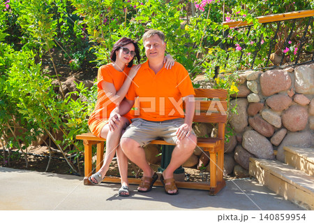 Happy husband and wife posing together for a vacation photo, smiling and enjoying their getaway Happy husband and wife posing together for a vacation photo, smiling and enjoying their getaway 140859954