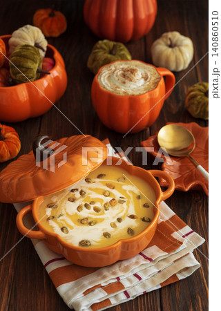 Warm pumpkin soup and latte with festive autumn decoration Warm pumpkin soup and latte with festive autumn decoration 140860510