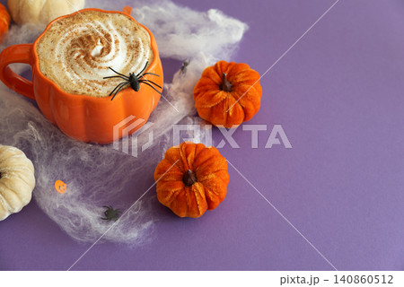 Halloween pumpkin spice latte with spider decoration 140860512