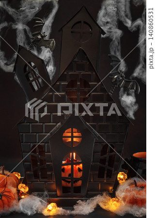 Halloween haunted house decorations with glowing pumpkin and bats Halloween haunted house decorations with glowing pumpkin and bats 140860531