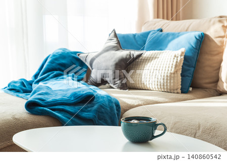 Cozy living room sofa with a warm cup 140860542
