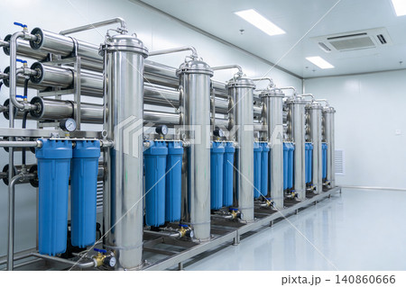 Industrial water filtration system with stainless steel tanks and blue filter housings Industrial water filtration system with stainless steel tanks and blue filter housings 140860666