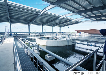 Modern water treatment plant with circular clarifiers and extensive piping systems 140860735