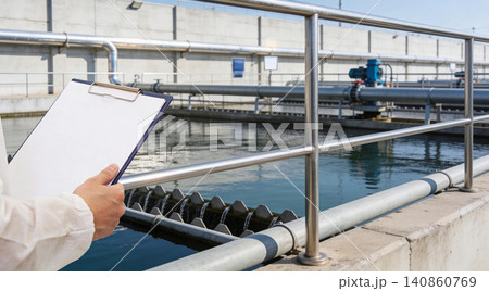 Water treatment plant inspection with clipboard and protective suit Water treatment plant inspection with clipboard and protective suit 140860769