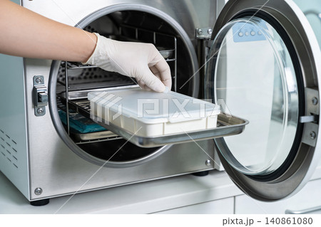 Sterilization process: placing medical instruments in an autoclave for disinfection 140861080