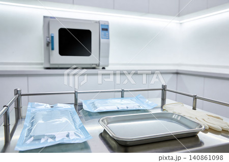 Sterile dental instruments and autoclave in a clean medical examination room Sterile dental instruments and autoclave in a clean medical examination room 140861098