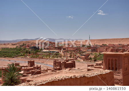 The Ksar of Ait Benhaddou rises majestically above the desert valley of Ouarzazate, Morocco. The Ksar of Ait Benhaddou rises majestically above the desert valley of Ouarzazate, Morocco. 140861550