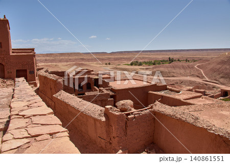 The Ksar of Ait Benhaddou rises majestically above the desert valley of Ouarzazate, Morocco. The Ksar of Ait Benhaddou rises majestically above the desert valley of Ouarzazate, Morocco. 140861551