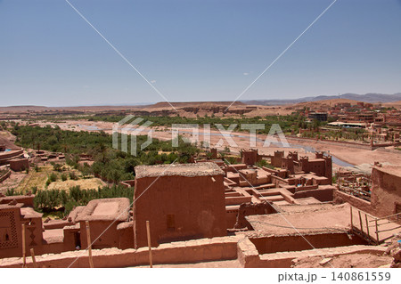 The Ksar of Ait Benhaddou rises majestically above the desert valley of Ouarzazate, Morocco. The Ksar of Ait Benhaddou rises majestically above the desert valley of Ouarzazate, Morocco. 140861559