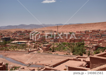 The Ksar of Ait Benhaddou rises majestically above the desert valley of Ouarzazate, Morocco. The Ksar of Ait Benhaddou rises majestically above the desert valley of Ouarzazate, Morocco. 140861561