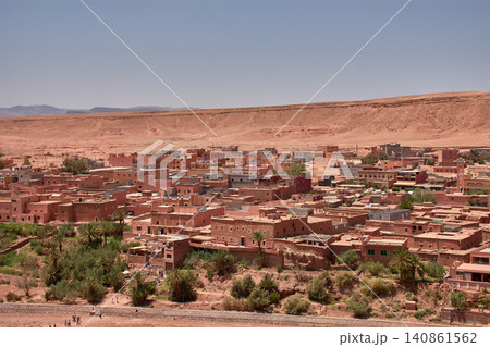 The Ksar of Ait Benhaddou rises majestically above the desert valley of Ouarzazate, Morocco. The Ksar of Ait Benhaddou rises majestically above the desert valley of Ouarzazate, Morocco. 140861562