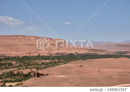 The Ksar of Ait Benhaddou rises majestically above the desert valley of Ouarzazate, Morocco. The Ksar of Ait Benhaddou rises majestically above the desert valley of Ouarzazate, Morocco. 140861567