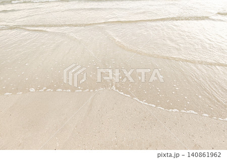Gentle ocean waves washing onto a sandy beach with copy space, creating a peaceful tropical seascape under natural sunlight. Gentle ocean waves washing onto a sandy beach with copy space, creating a peaceful tropical seascape under natural sunlight. 140861962