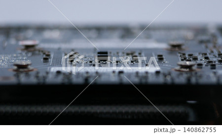 Macro close-up of a graphics card printed circuit board with electronic components, microchips and surface mount devices. Technology, computing and hardware concept Macro close-up of a graphics card printed circuit board with electronic components, microchips and surface mount devices. Technology, computing and hardware concept 140862755