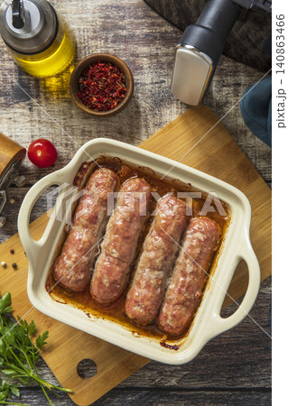 Grilled sausages baked with vegetables on a stone countertop. Healthy eating, quick cooking. Comfort food meal. Top view flat lay background. Grilled sausages baked with vegetables on a stone countertop. Healthy eating, quick cooking. Comfort food meal. Top view flat lay background. 140863466