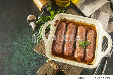 Grilled sausages baked with vegetables on a stone countertop. Healthy eating, quick cooking. Comfort food meal. Copy space. Grilled sausages baked with vegetables on a stone countertop. Healthy eating, quick cooking. Comfort food meal. Copy space. 140863469
