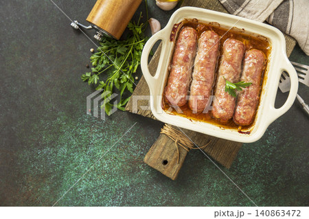 Grilled sausages baked with vegetables on a stone countertop. Healthy eating, quick cooking. Comfort food meal. Top view flat lay background. 140863472