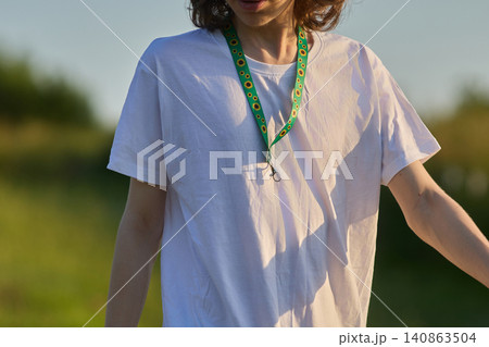 Person wearing sunflower lanyard for hidden disability awareness 140863504