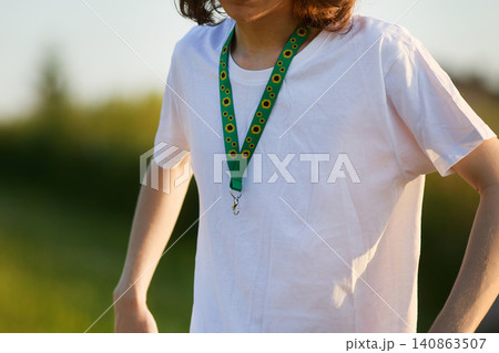 Person wearing sunflower lanyard indicating hidden disability awareness 140863507