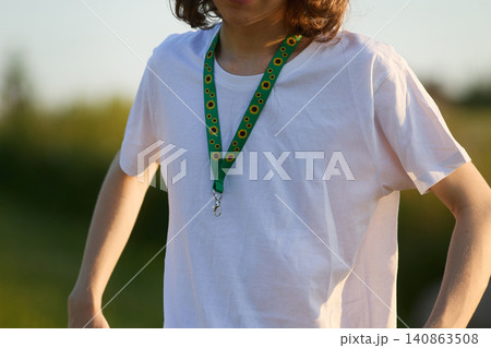 Person wearing hidden disability sunflower lanyard 140863508