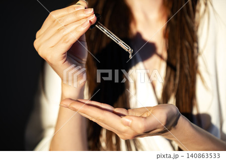 Woman Applying Facial Serum With Glass Dropper During Skincare Routine, Beauty Treatment, Healthy Skin, Daily Self Care And Premium Cosmetic Concept Woman Applying Facial Serum With Glass Dropper During Skincare Routine, Beauty Treatment, Healthy Skin, Daily Self Care And Premium Cosmetic Concept 140863533