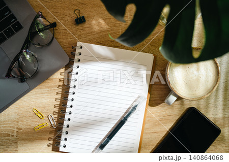 Home office workspace with notebook, coffee and smartphone on wooden desk, top view 140864068