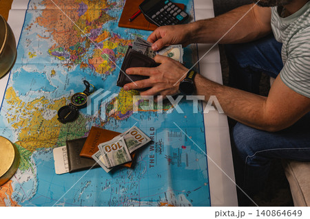 Planning a travel budget with cash and a map for future trips Planning a travel budget with cash and a map for future trips 140864649