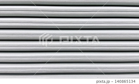 Close-up of white slatted wall texture with horizontal linear pattern and clean surface. Close-up of white slatted wall texture with horizontal linear pattern and clean surface. 140865134