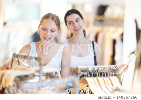 Two women choosing dress in clothing store Two women choosing dress in clothing store 140867266