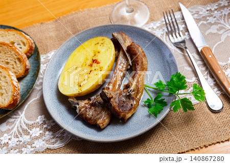 Roasted lamb ribs with boiled potato and greens 140867280