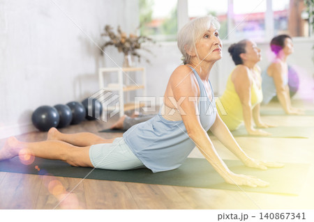 Group of elderly woman doing yoga on mat in studio 140867341