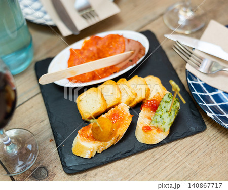 Different types of tapas on table 140867717