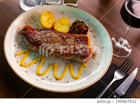 Fried piece of beef with potato and vegetables Fried piece of beef with potato and vegetables 140867812