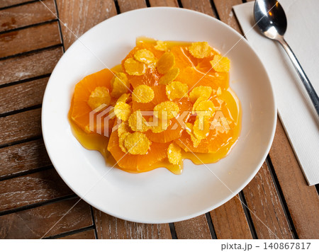 Orange served with honey and corn flakes 140867817