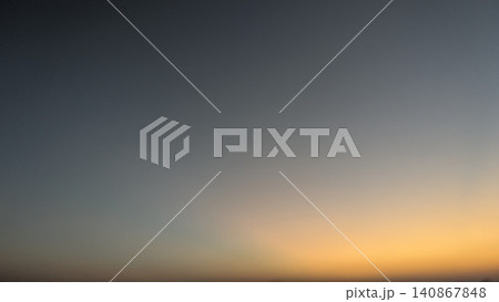A minimal beautiful dawn sky landscape captures a smooth soft color gradient transition at dawn. The clear horizon glow shifts from deep moody blue down to warm vibrant orange, offering an elegant A minimal beautiful dawn sky landscape captures a smooth soft color gradient transition at dawn. The clear horizon glow shifts from deep moody blue down to warm vibrant orange, offering an elegant 140867848