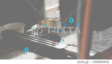 Sitting metal clamp resting on worn workbench in workshop, showing ribbed handle and blue glyphs 140869442