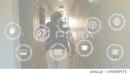 Walking senior man using cane and wearing dark vest in narrow well-lit corridor, icons overlaying Walking senior man using cane and wearing dark vest in narrow well-lit corridor, icons overlaying 140869475
