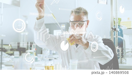 Pipetting senior scientist in white lab coat goggles at lab bench, handling pipette beaker data HUD 140869508