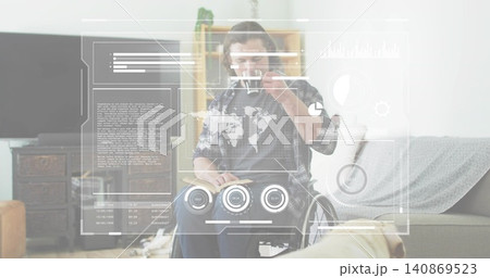 Holding mug and reading open book, man in wheelchair wearing plaid shirt at home with HUD Holding mug and reading open book, man in wheelchair wearing plaid shirt at home with HUD 140869523